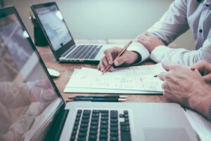 Real estate lawyer reviewing property contract with client in office